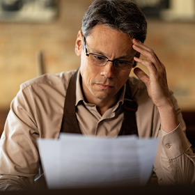 A Worried Man Looking At a Paper