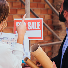 Two People Inspecting a Real Estate Property