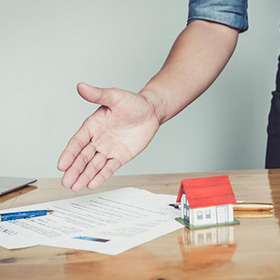 A Man's Hand Pointing at a Piece of Paper